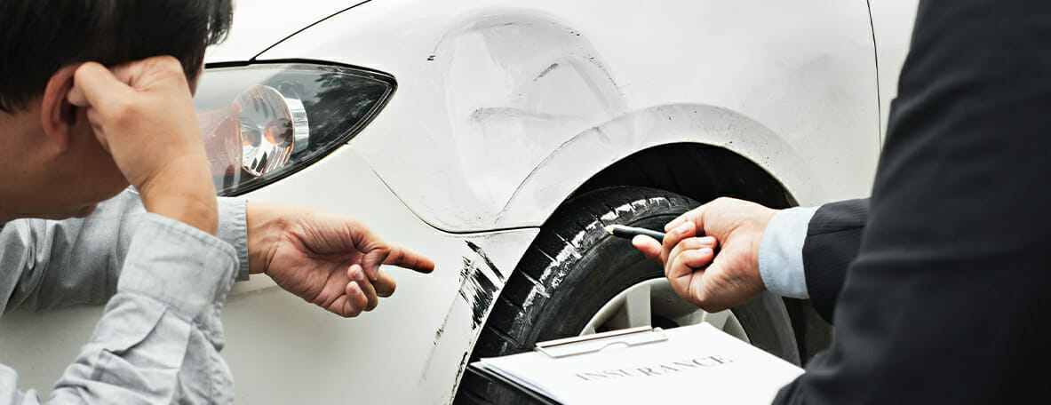 People view damage to a car.
