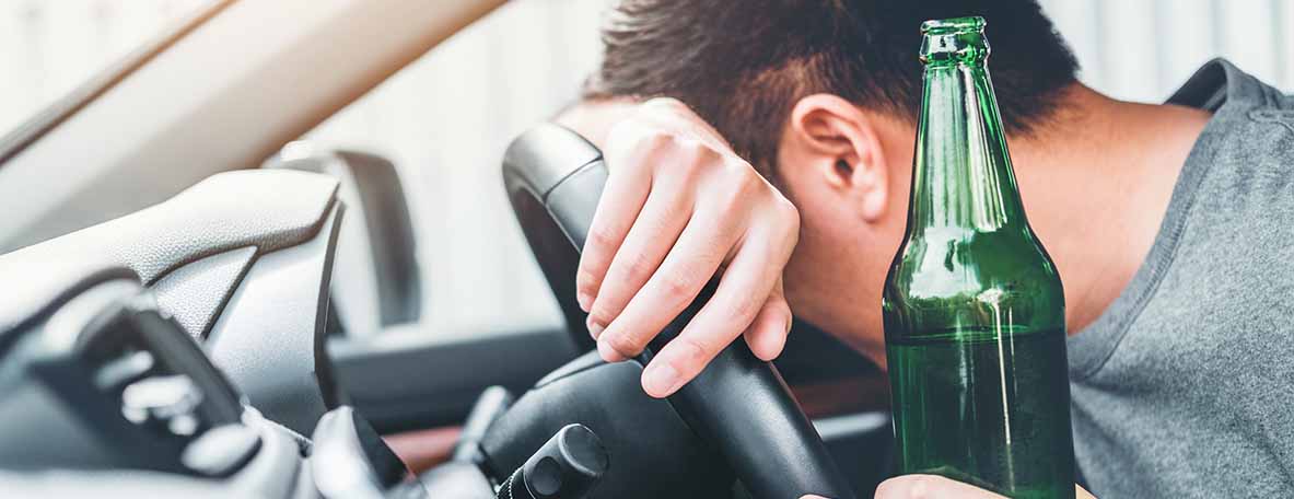 beer in hand passed out behind wheel of car | dwi attorney
