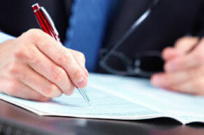 Person writing a document
